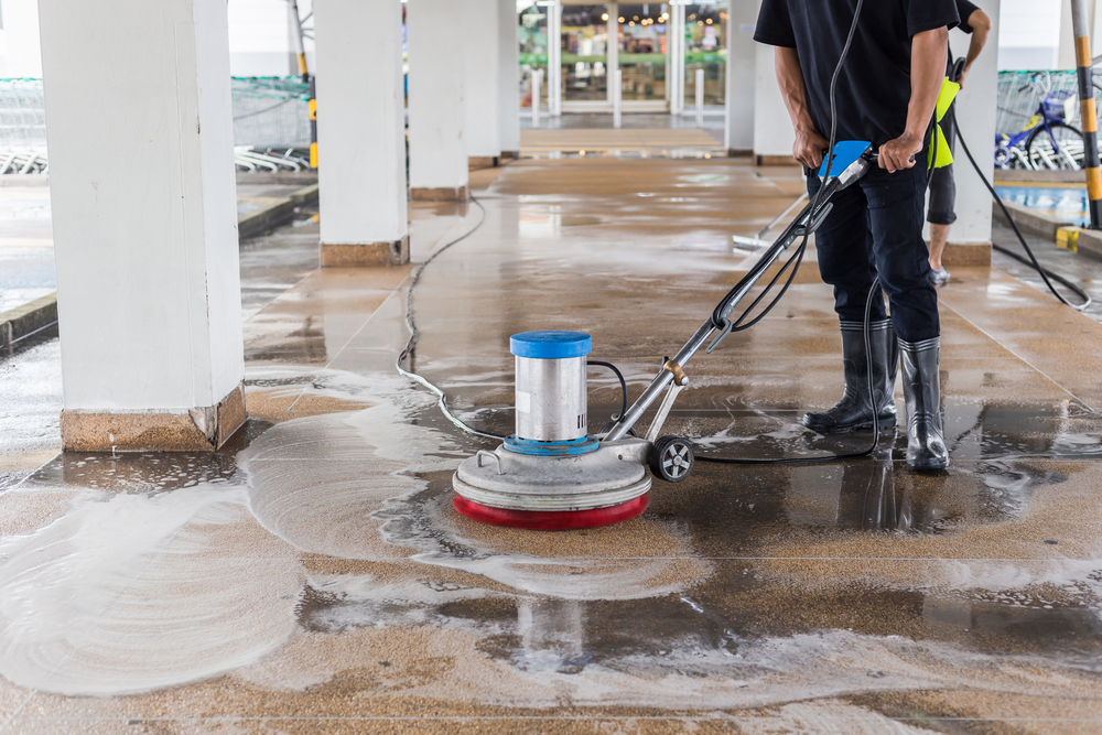 a man cleaning a floor with eco-friendly chemicals